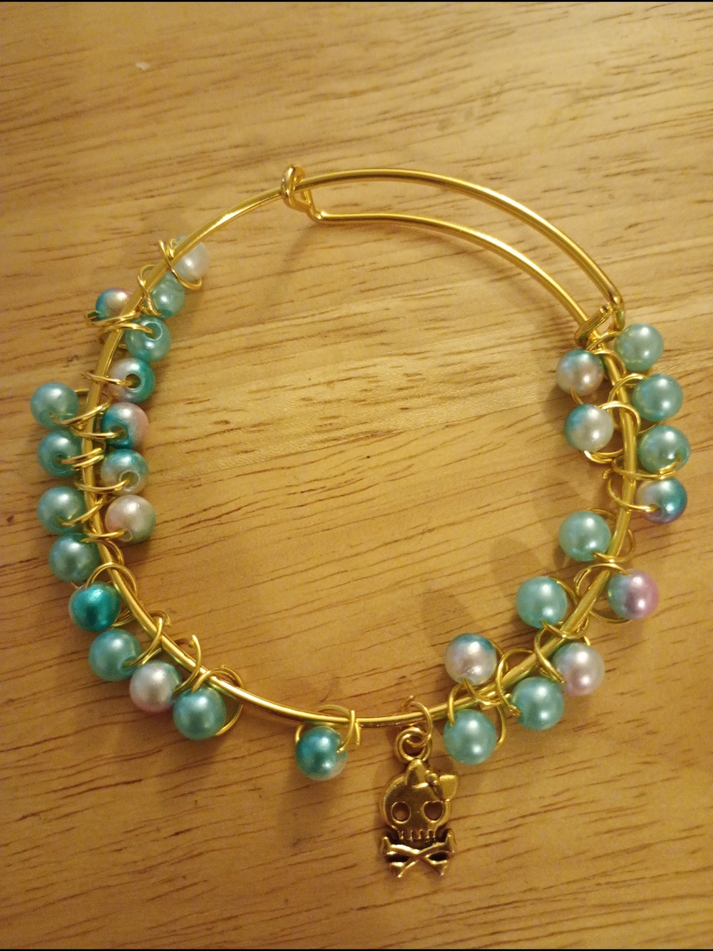 Gold Wire Bangle with Aqua Pearl Beads and Skull Charm